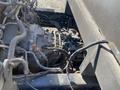 A 2019 Hino 195 engine and transmission system with visible pipes and wiring connections