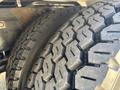 Close-up of a rugged tire from a 2020 Peterbilt 330 showcasing its deep tread pattern designed for traction and stability on various terrains
