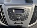 Dashboard of a 2019 Ford Transit 350 featuring radio controls a media interface and air conditioning settings