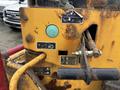 A close-up view of a 2015 Vermeer Corporation BC1200XL chipper control panel featuring various symbols and buttons with visible wear and rust