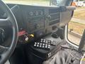 Interior view of a 2020 Chevrolet Express showing the dashboard with controls a stereo system and a key ignition system