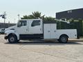 A white 2006 Sterling Acterra truck with a flatbed and utility compartments on the side