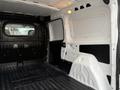 Interior of a 2017 RAM ProMaster City cargo van showing a spacious and empty cargo area with a black rubber floor and white walls