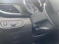 A close-up view of the interior dashboard controls of a 2018 Buick Encore featuring dials and buttons for settings and adjustments