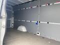 Interior of a 2024 Mercedes-Benz Sprinter van showing a spacious, unmarked cargo area with gray walls and a smooth floor