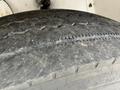 Close-up of a worn-out tire on a 2012 Global M4 showing significant tread wear and visible grooves on the surface
