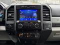 Interior view of a 2021 Ford F600 showcasing a touchscreen display with controls for audio and climate settings