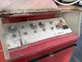 Control panel of a 2010 International 4300 featuring various knobs and buttons including a power switch and an emergency stop button
