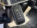 Close-up of a gear shift control panel featuring buttons for park reverse neutral drive and mode indicator with a digital display