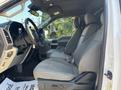 Interior of a 2019 Ford F-150 showcasing the front seats with gray fabric upholstery and a clean dashboard with controls and steering wheel visible