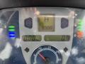 Dashboard of a 2009 New Holland T4020 displaying gauges with a digital readout showing 9300 hours and speedometer reading 0 km/h