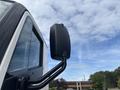 A side mirror of a 2020 Lion Lion6 vehicle attached to the door with a sleek black design and a curved arm