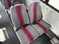 Interior of a 2011 Freightliner B2 featuring gray seats with red stripes and seat belts