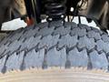 Close-up of the tread of a tire from a 2011 Ford F-550 showing wear patterns and grooves designed for traction