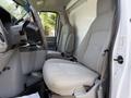 Interior of a 2018 Ford E-450 van featuring two gray fabric seats and a central console in the front cabin