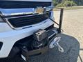 A 2017 Chevrolet Colorado with a winch mounted on the front bumper and a hook attached to the winch cable