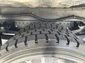 Close-up of a tire from a 2018 Hino 195 displaying a rugged tread pattern and metal rim
