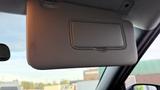 A 2019 Nissan Kicks sun visor in a car with a closed mirror cover
