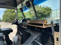 Interior view of a 2011 Workhorse W62 featuring a steering wheel dashboard control panel and a wooden shelf over the driver’s seat