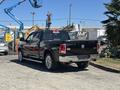 A black 2015 RAM 1500 pickup truck with a chrome rear bumper and tailgate featuring the RAM logo