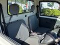 Interior view of a 2009 Daihatsu Hijet showing two front seats with fabric upholstery and a steering wheel visible in the foreground