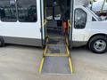 A 2020 Chevrolet Express van with an extended ramp for wheelchair access in the foreground