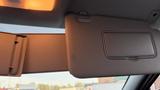 The image shows a vehicle sun visor with a foldable section and a small vanity mirror cover in a 2019 Nissan Kicks