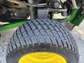 Close-up of a John Deere 1575 tractor tire showcasing its tread pattern and yellow rim