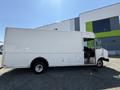 A white 2012 Ford Econoline delivery truck with a step side door and no visible branding on the exterior