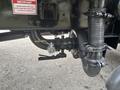 Close-up of a 2006 Freightliner M2 106's engine components including the water pump a pipe and a valve