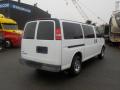 A white 2011 Chevrolet Express van with a simple design featuring large windows and chrome wheels viewed from the rear