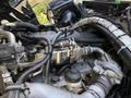 Close-up view of the engine compartment of a 2009 International 3000 CE with visible metal components hoses and electrical connections