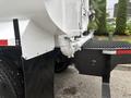 A 2006 Freightliner M2 106 truck showing a close-up of its rear section with a metallic hose and attachment on the side and large tires underneath