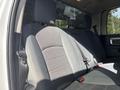 The image shows the back seat of a 2014 RAM 5500 with gray fabric upholstery and a seatbelt on the left side