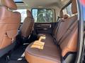 Interior view of a 2015 RAM 1500 showing brown leather rear seating and upholstery with a spacious layout