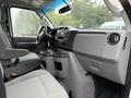 Interior view of a 2022 Ford Econoline showing the driver's seat dashboard and center console with cup holders and control knobs