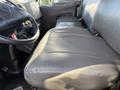 A close-up view of the driver's seat and dashboard area of a 2017 International 4300 truck showing gray upholstery and interior details