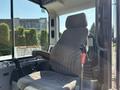 A 2010 Bobcat E80 operator seat with control levers visible on either side