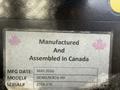 A nameplate displaying the details of a 2017 International 4300, including manufacturing date and model information with pink maple leaf designs