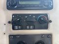 Dashboard controls of a 2008 Peterbilt 340 featuring climate control dials and radio interface with buttons for air conditioning and recirculation