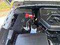 Close-up of the engine compartment of a 2021 Jeep Wrangler featuring the battery and various engine components