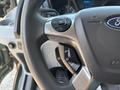 Close-up of a steering wheel from a 2016 Ford Transit 150 showing controls for audio and cruise settings
