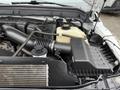 A close-up view of the engine bay of a 2015 Ford F-350 SD showing air intake and various engine components in a neatly organized layout