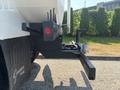 A 2008 Peterbilt 340 truck with a black rear bumper featuring a red light and various attachment points for equipment and hoses