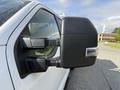 Close-up of the side mirror of a 2021 Ford F-150 showcasing the reflective surface and integrated turn signal