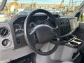 Interior view of a 2013 Ford E-350 Super Duty showing the steering wheel dashboard and control panel