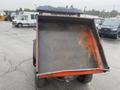 A 2010 Kubota RTV 900 with an open dump bed showcasing a textured metal surface and a robust truck design