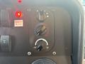 Control panel of a 2018 Ford Econoline featuring temperature adjustment knobs and a warning light for door ajar