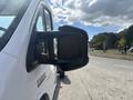 A white 2023 RAM Promaster 3500 vehicle with a prominent side mirror visible in the foreground