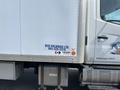 A 2018 Hino 338 truck with a white cargo box and company branding visible on the side